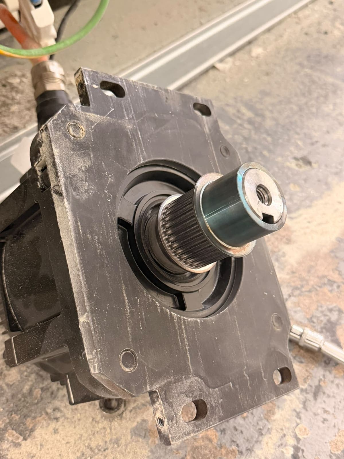 A drive unit removed from a CNC machine and stood on the workshop floor, splined shaft facing up